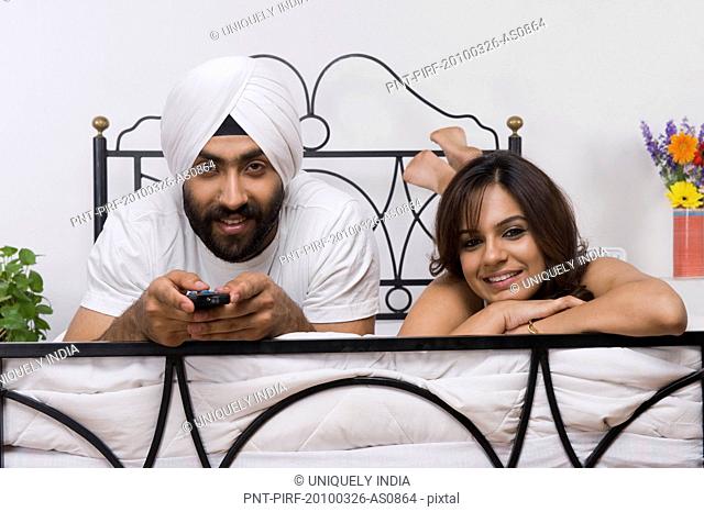 Portrait of a Sikh couple lying on the bed