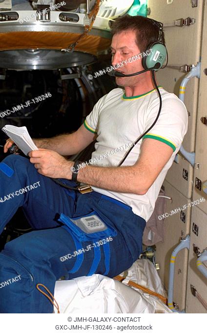 Cosmonaut Sergei Y. Treschev, Expedition Five flight engineer, uses an amateur radio in the functional cargo block (FGB) on the International Space Station...