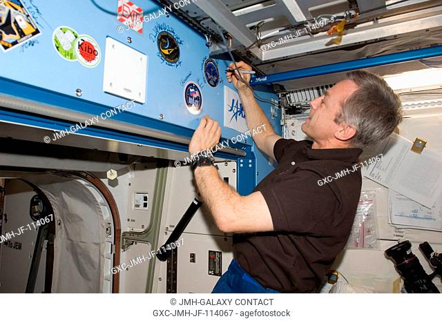 Flight day 11 activities for the joint shuttle-station crews included the traditional autographing of the station. Canadian Space Agency astronaut Robert Thirsk