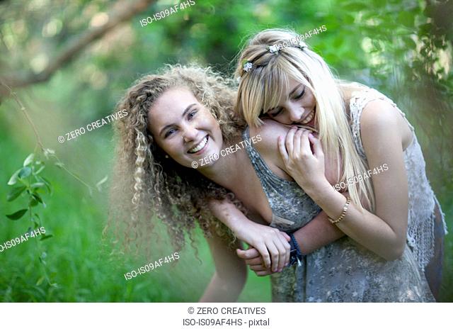 Two teenage girls having fun in woodland