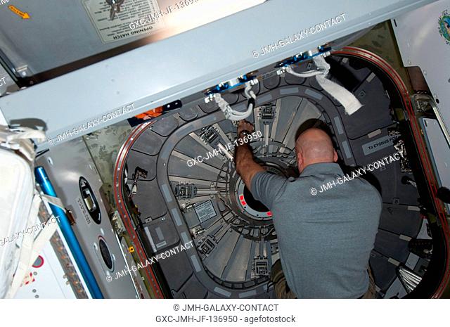 European Space Agency astronaut Luca Parmitano, Expedition 37 flight engineer, closes the hatch between the International Space Station's Harmony node and the...