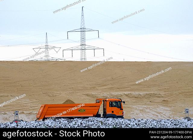 04 December 2023, Saxony-Anhalt, Niedere Börde: A truck rolls over the construction site for the next section of the A14 north of Magdeburg