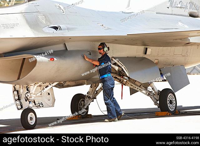 Ground Crew Member Inspects an F-16 Just Prior to Launch