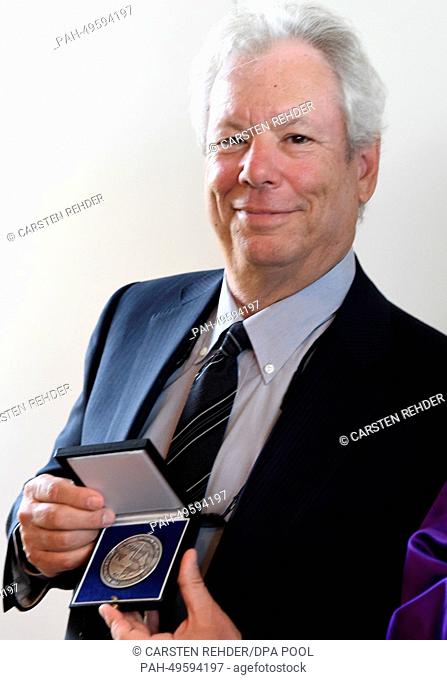 The winners of the Global Economy Prize US economist Richard Thaler holds his medal in Kiel, Germany, 22 June 2014. The award is presented annually as part of...