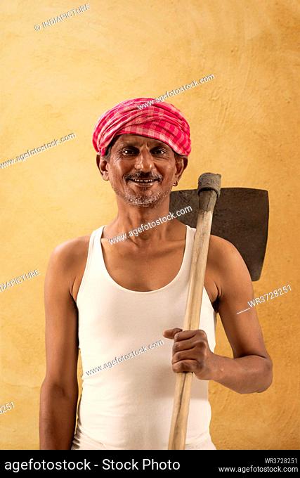 Portrait of a Farmer holding a Shovel