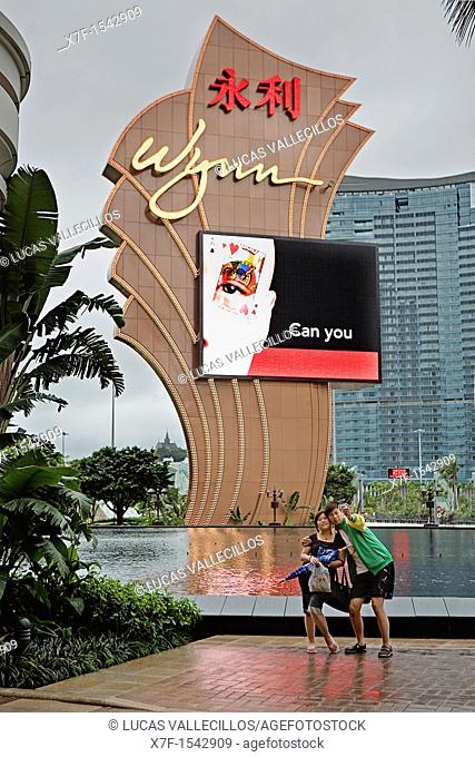 Couple taking picture in Main entry to Wynn hotel & casino, Macau, China