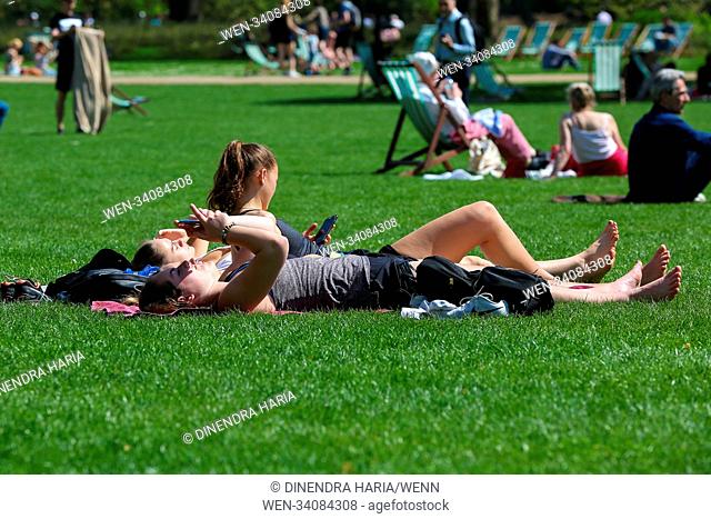 Tourist and Londoners enjoy third day of hot weather in Green Park and St. James's Park as the temperatures in the capital likely to reach 26 degree celsius