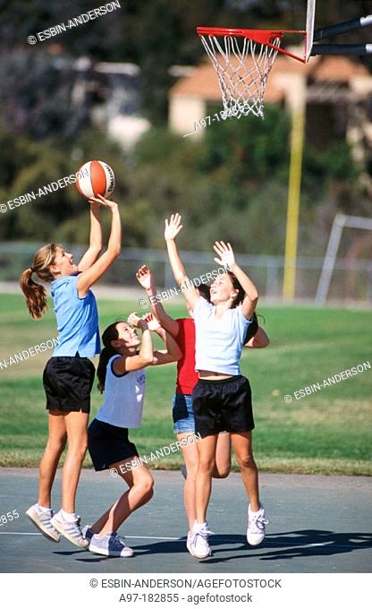 Teen girls playing basketball