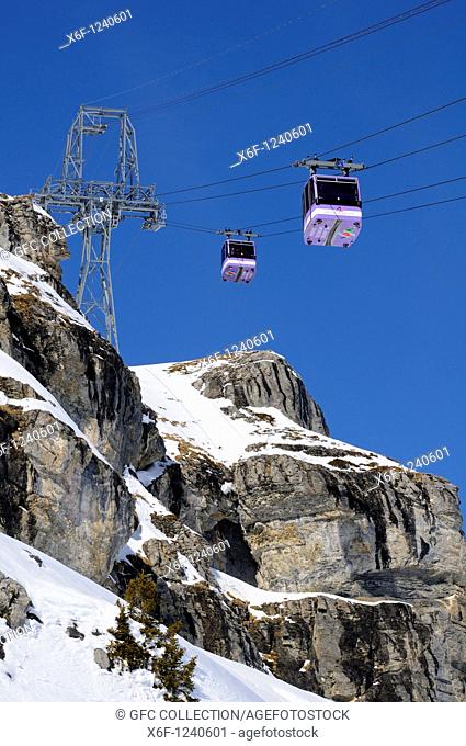 Pylons and passenger cabins of the funitel Plaine Morte in the rocks, Crans Montana, Valais, Switzerland