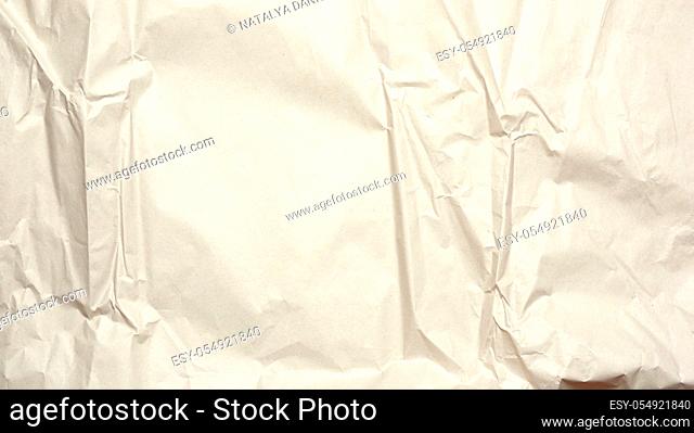 crumpled blank sheet of gray wrapping kraft paper, texture for the designer, full frame