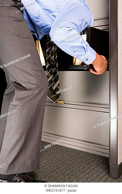 Businessman with his head in a drawer