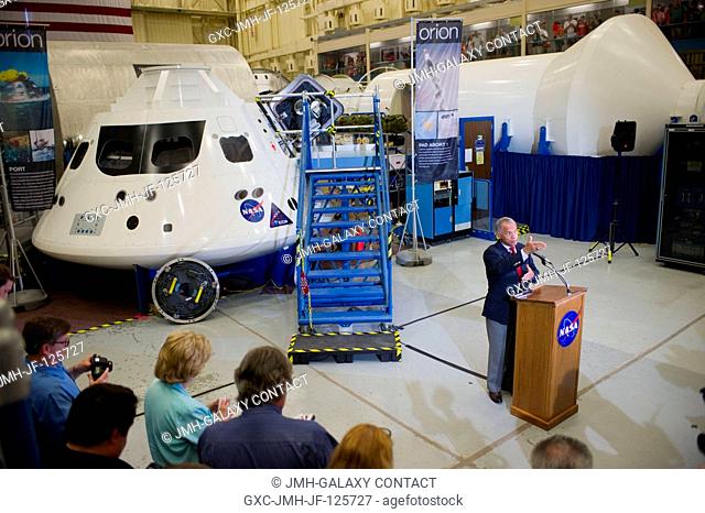 NASA Administrator Charlie Bolden speaks to media representatives (largely out of frame) as he visits the Orion mock-ups at the Johnson Space Center in Houston