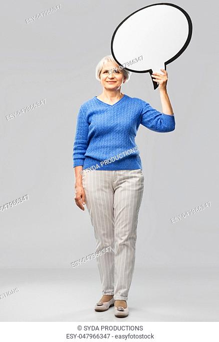 smiling senior woman holding big speech bubble
