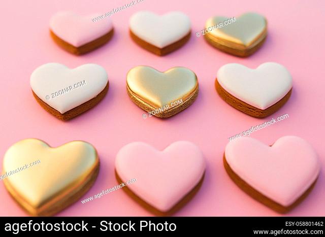 Pink background with sweet gingerbread heart cookies. High quality photo
