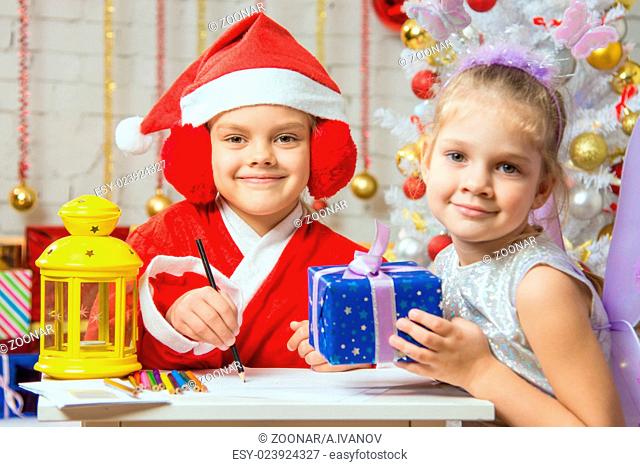 Santa Claus and fairy helper prepared greeting cards and presents