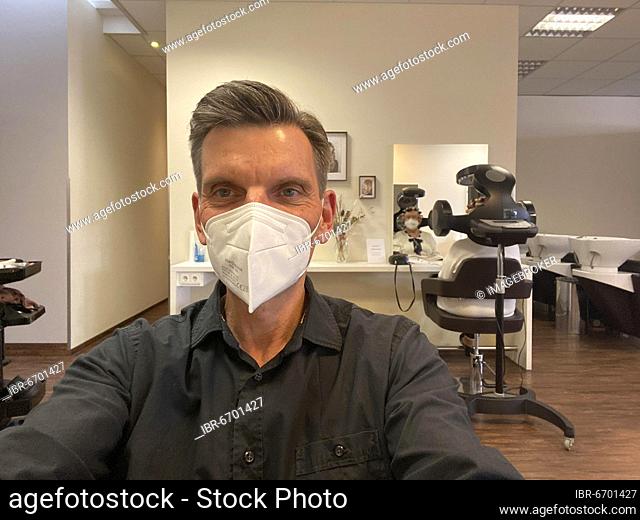 Customer with FFP2 mask at hairdresser, happy about haircut, hair salons reopen during lockdown, Corona crisis, Stuttgart, Baden-Württemberg, Germany, Europe