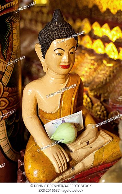 Buddha statue with offerings at Wat Phnom temple Phnom Penh, Cambodia