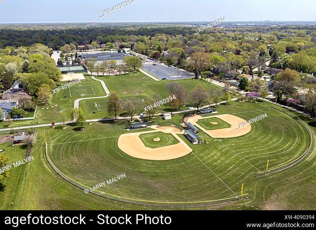 Aerial view of a large playfield in a suburban neighborhood with ballfields, tennis courts, and soccer fields