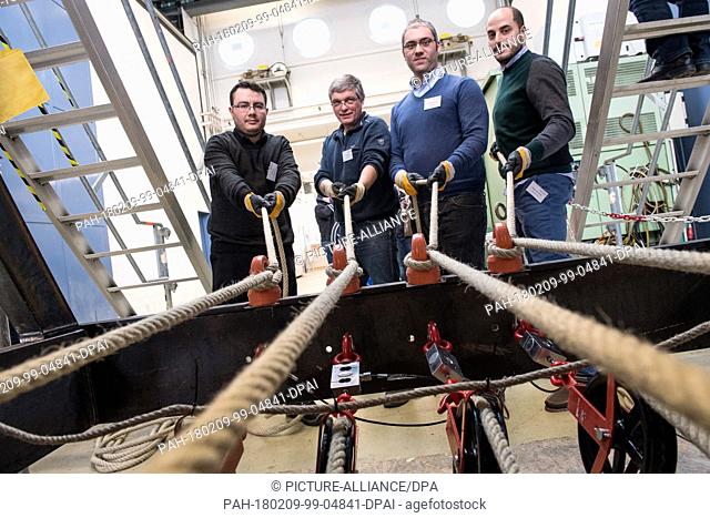 The scientists Ali Gueney (L-R), Uwe Dorka, Antonio Ansalone and Angelo Mammone let down the ton-heavy stone blocks in the true to the original 1-1 replica of a...