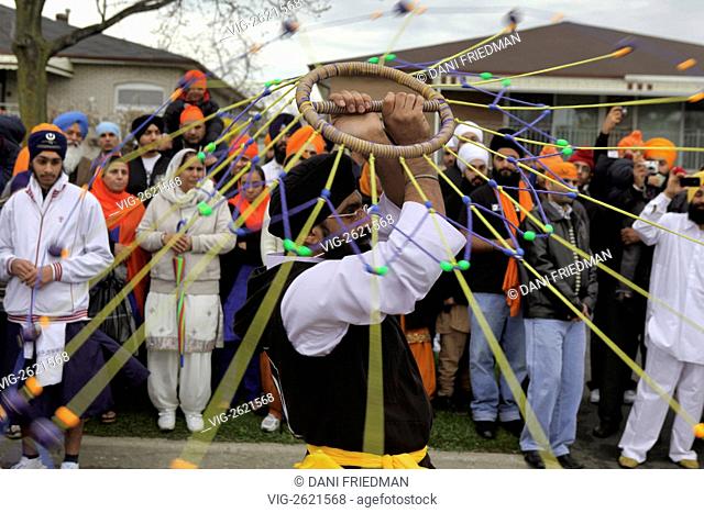 CANADA, MISSISSAUGA, 01.05.2011, A Sikh youth twirls a traditional net weapon during a gatka (Sikh martial arts) performance at a Nagar Kirtan during Vaisakhi