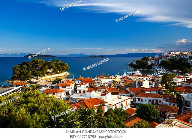 View of the old harbour on Skiathos island and Euboea in the distance, Greece.