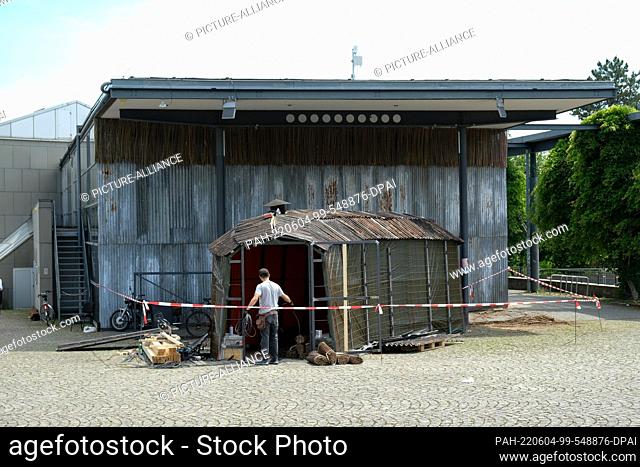 03 June 2022, Hessen, Kassel: A man works on the reconstruction of the entrance area of the documenta hall. The world art show documenta fifteen begins on June...