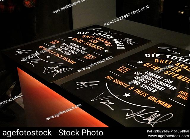 23 February 2023, North Rhine-Westphalia, Duesseldorf: Posters of the Toten Hosen concert lie on a counter. On Friday, the Toten Hosen will give a benefit...
