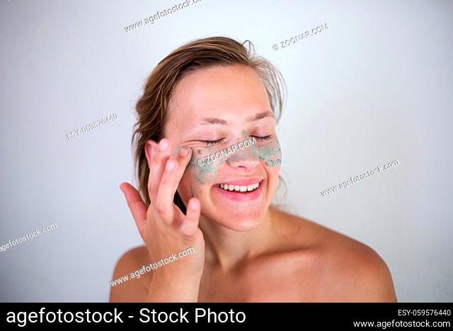 Young emotional woman with facial mask