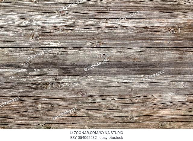 Rough wooden wall with knots and horizontal panels. It can be used as texture and backgrounds
