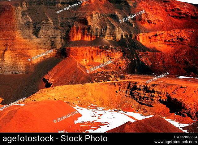 Martian landscapes in Iceland. The red crater of The Seydisholar volcano. The quarry of red soil mining. High quality photo