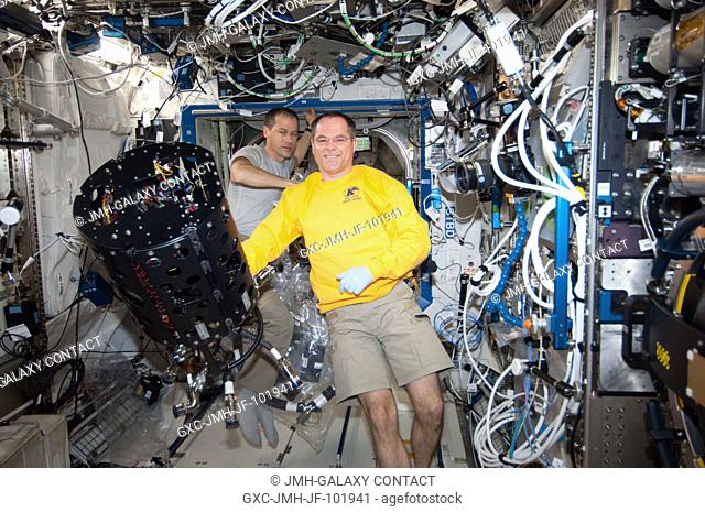 NASA astronauts Kevin Ford (foreground), Expedition 34 commander; and Tom Marshburn, flight engineer, work with the Combustion Integrated Rack (CIR) Multi-user...