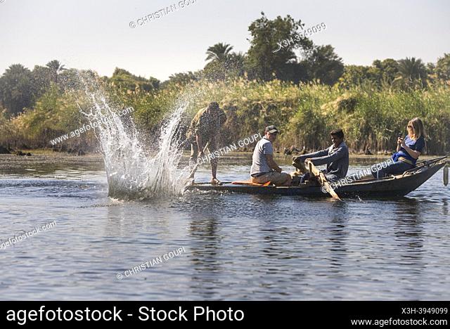 Tourists in the company of net fishermen in rowing boat, village of Ramadi, west bank of the Nile south of Edfu, Egypt, North East Africa