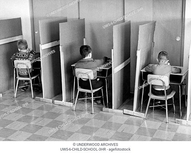 Worcester, Massachusetts: c. 1955.First grade students that have been segregated in cubicles from the rest of the class