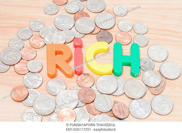 Rich alphabet with various US coins, stock photo