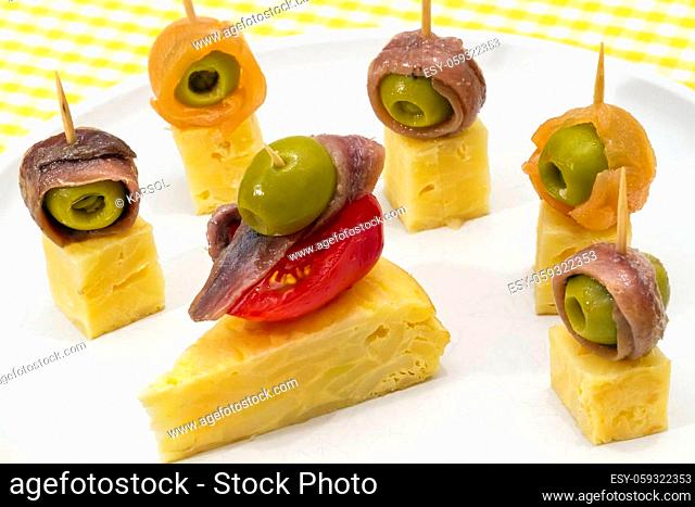 Delicious Appetizer Plate with Salmon, anchovies and Olives. Spanish tortilla mounted