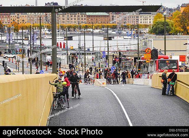 Stockholm, Sweden Bicyclists riding the new Slussbron, or Golden Bridge, at Slussen, inaugurated Oct 25, 2020