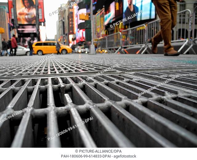 1 February 2018, USA, New York: Pedestrians walk over grids under which a sound installation of the US artist Max Neuhaus is placed