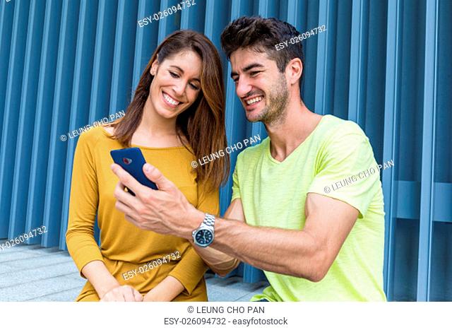 Caucasian couple use of cellphone together