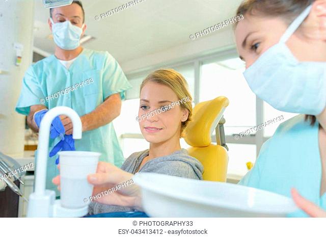 dental assistant putting water