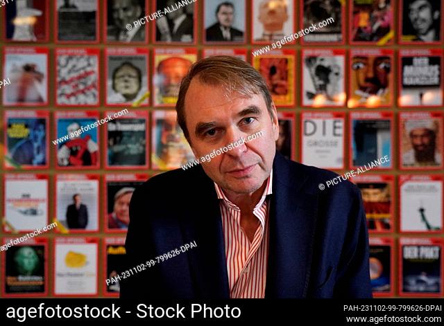 02 November 2023, Hamburg: Dirk Kurbjuweit, Editor-in-Chief of the news magazine ""Der Spiegel, "" stands in front of a wall of ""Spiegel"" title pages in the...