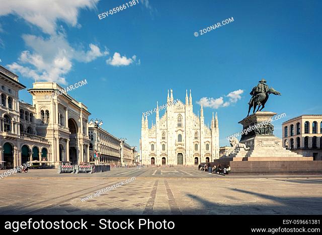 Long exposure of Milan cathedral Duomo and Vittorio Emanuele statue in Square Piazza Duomo at sunny day and clouds, Milan, Italy