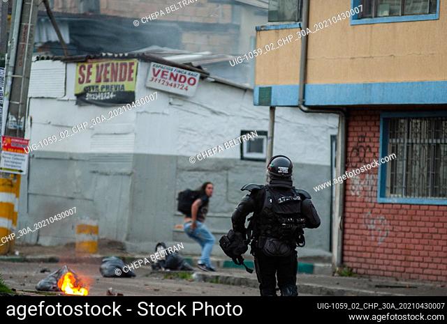 A riot police officer from ESMAD pursuits a demonstrator in Bogota, Colombia clashes happened soon after demonstrators tried to enter the shopping mall...