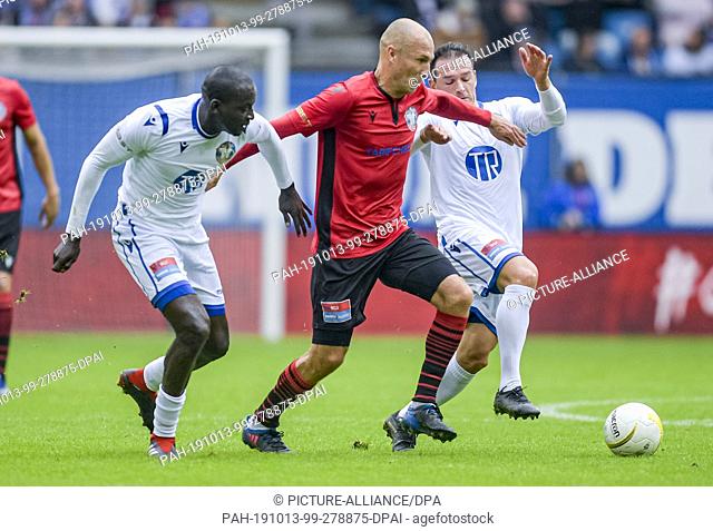 13 October 2019, Hamburg: Timothy Atouba from the HSV Allstar team, (l-r) Arjen Robben (l) from the Dutch Allstar team and Piotr Trochowski from the HSV Allstar...