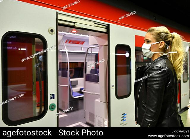 Woman with respirator mask, waiting for train, S-Bahn, Corona crisis, Stuttgart, Baden-Württemberg, Germany, Europe