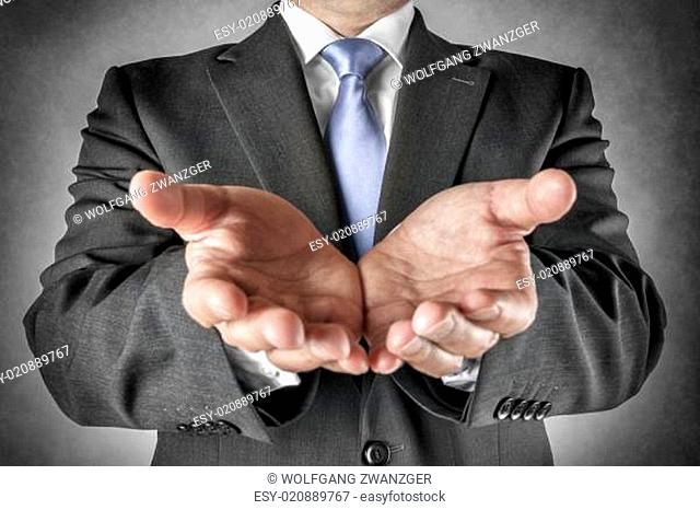 Businessman holds out hands