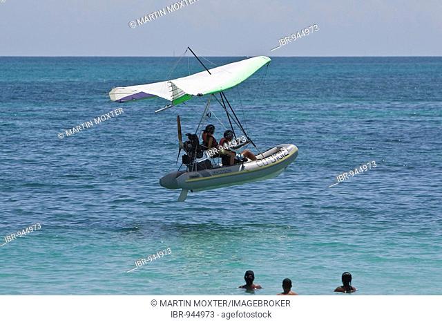 Motorised hang glider landing on the sea, UL-Trike, Ultra Light airplane with a life boat, Varadero, Cuba, Caribbean, Central America, America