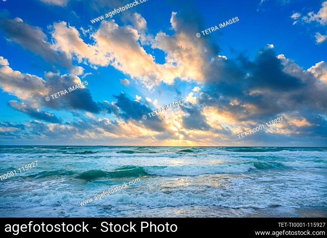 Clouds over sea at sunset