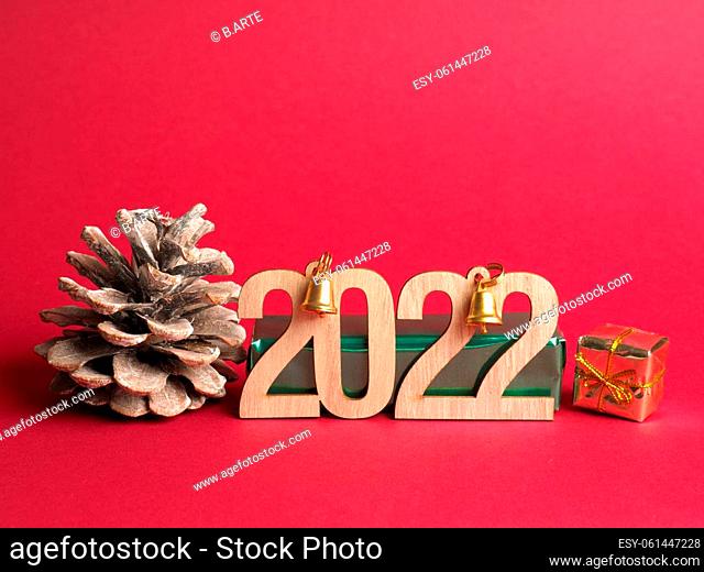 Christmas decoration with the Year number 2022 in wooden letters on a red background with space for text