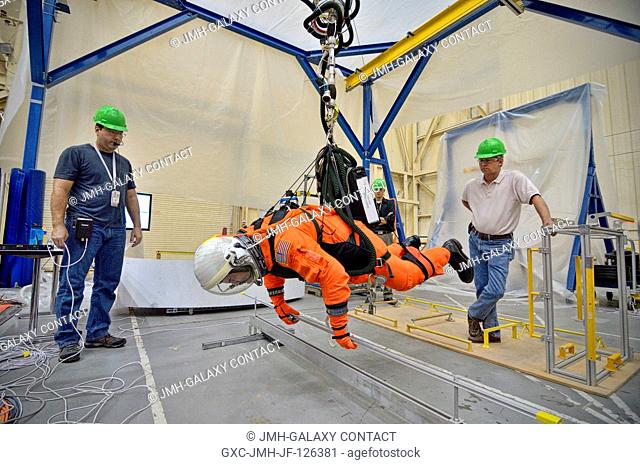 NASA Astronaut Rex Walheim participates in an evaluation of the Advanced Crew Escape Suit (ACES) in the Active Response Gravity Offload System (ARGOS) at the...