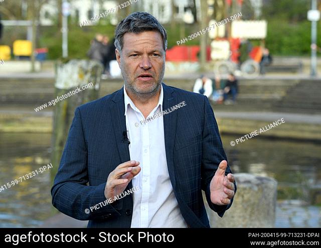15 April 2020, Schleswig-Holstein, Flensburg: Robert Habeck, Federal Chairman of Bündnis 90/Die Grünen, talks to journalists at the harbour of his home town